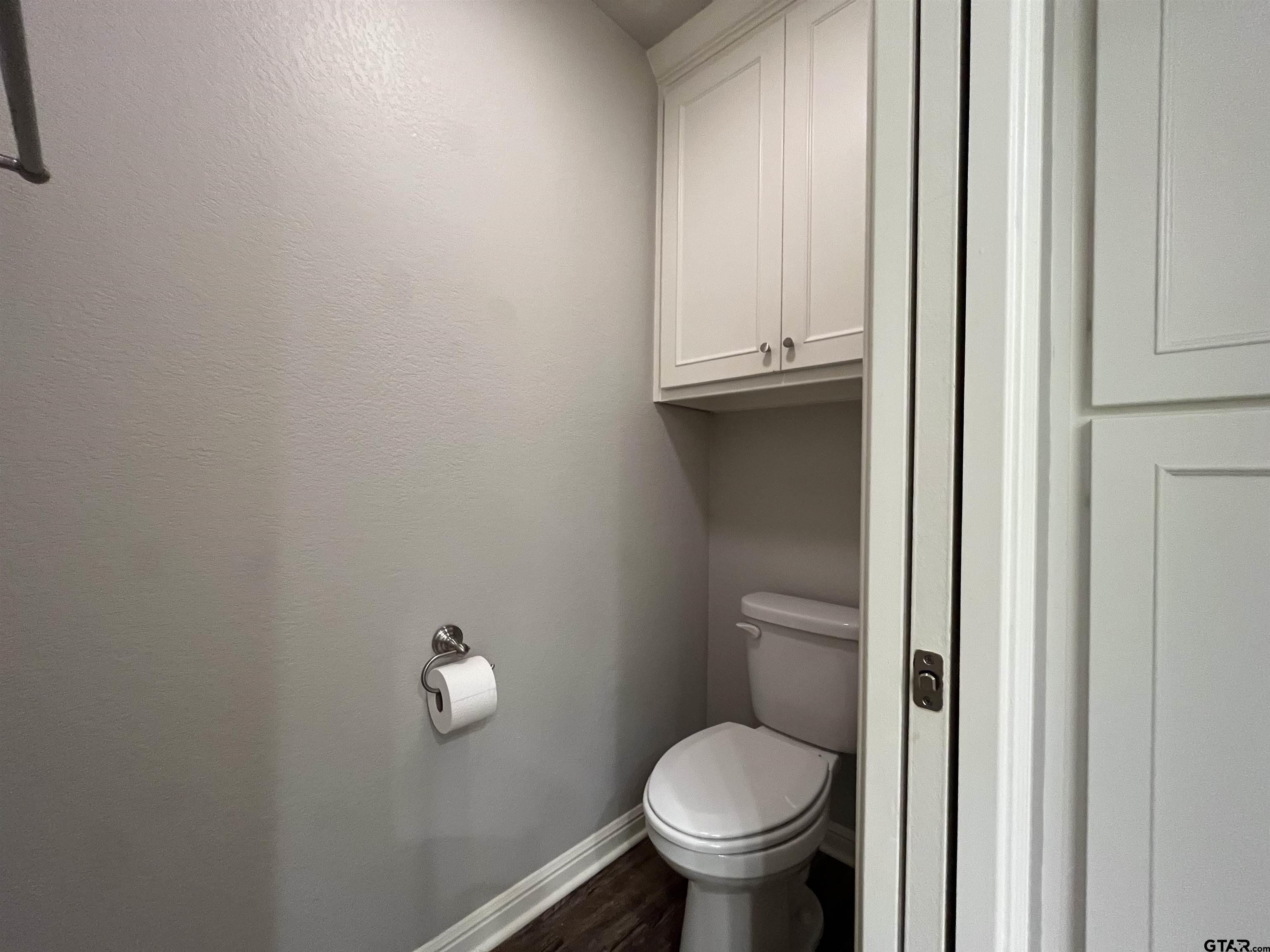5429 Meadow Ridge Drive Flint, TX 75762 - Photo 20 of 24 a bathroom with a granite countertop toilet and a sink