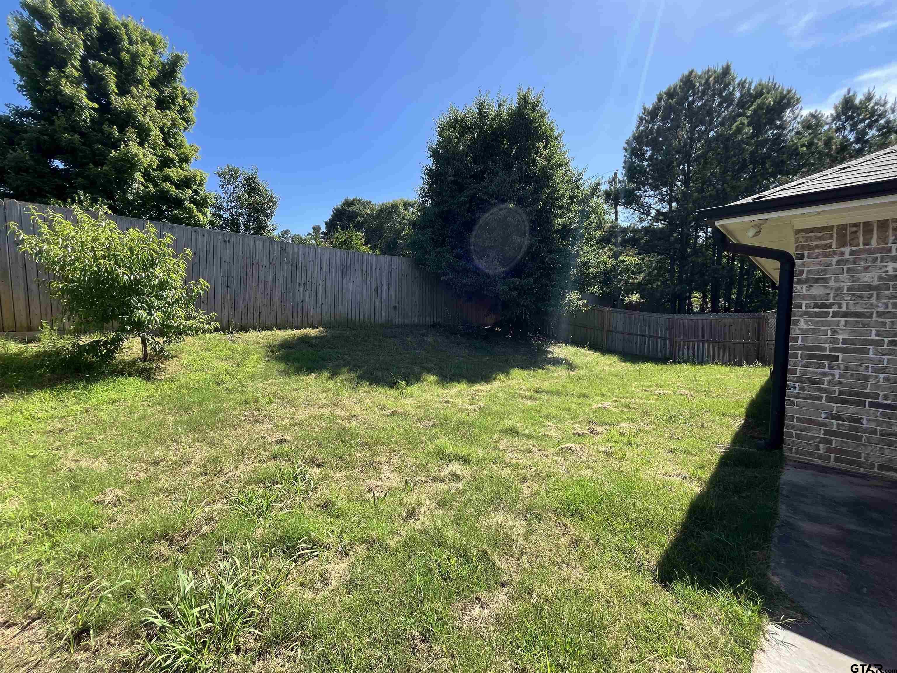 5429 Meadow Ridge Drive Flint, TX 75762 - Photo 24 of 24 a view of a backyard with a garden