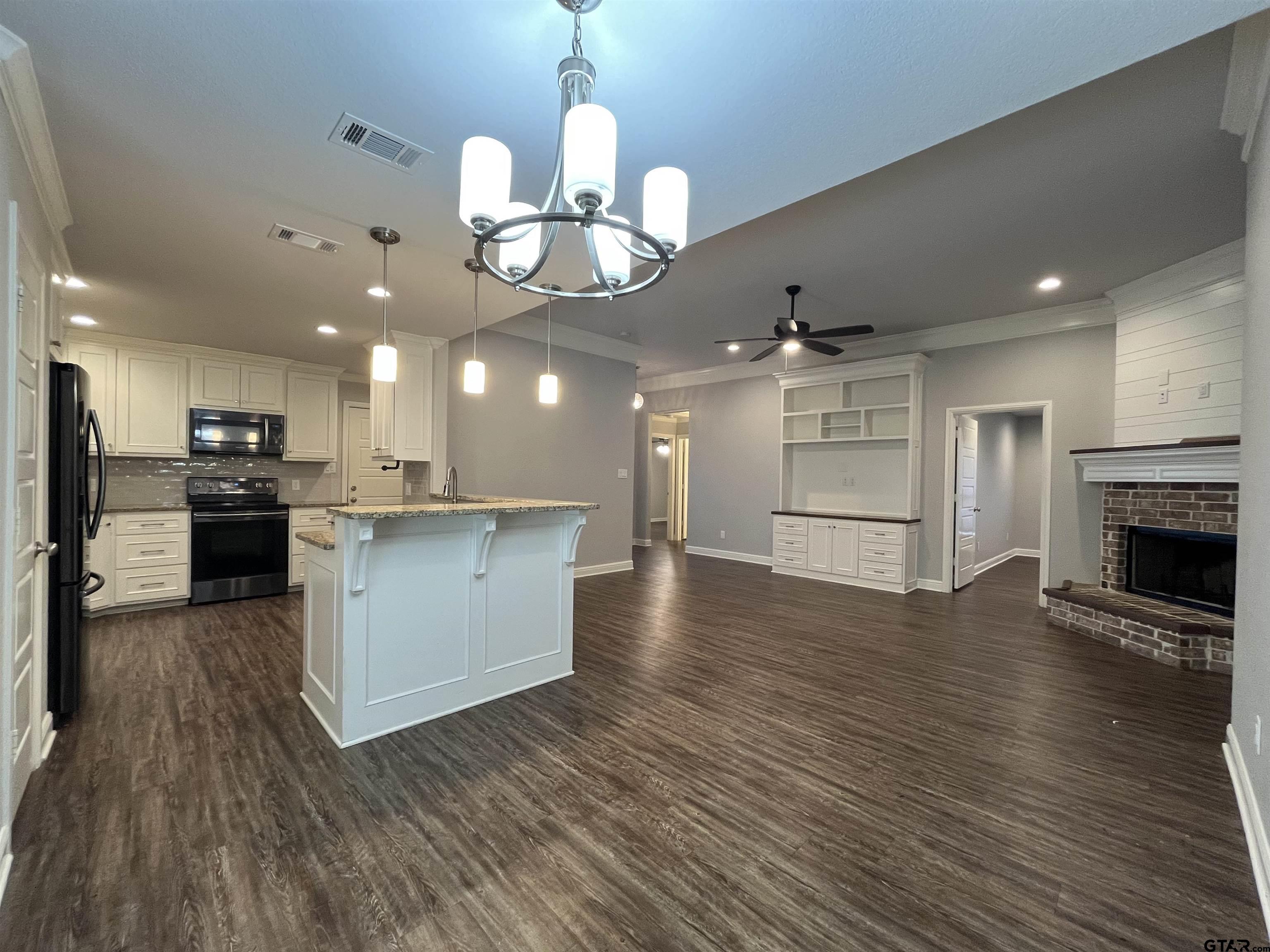 5429 Meadow Ridge Drive Flint, TX 75762 - Photo 6 of 24 a view of a kitchen with a sink a refrigerator and a stove top oven
