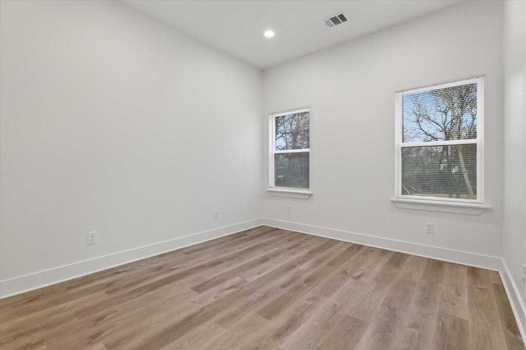1334 Grant Street Dallas, TX 75203 - Photo 12 of 21 a view of empty room with wooden floor and fan