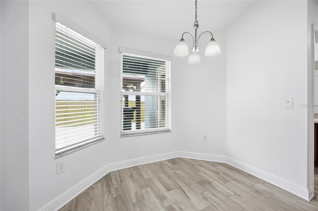 4863 Southwest 63rd Street Ocala, FL 34474 - Photo 11 of 41 an empty room with wooden floor and windows
