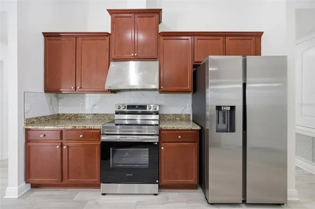 a kitchen with a refrigerator sink and stove