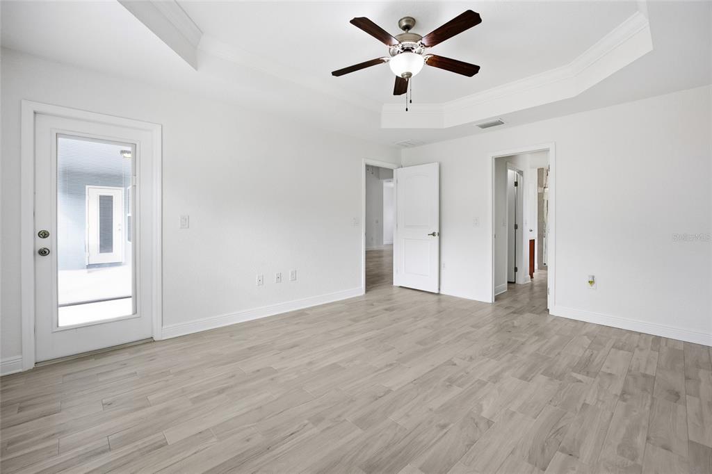 4863 Southwest 63rd Street Ocala, FL 34474 - Photo 18 of 41 a view of an empty room with a window and wooden floor