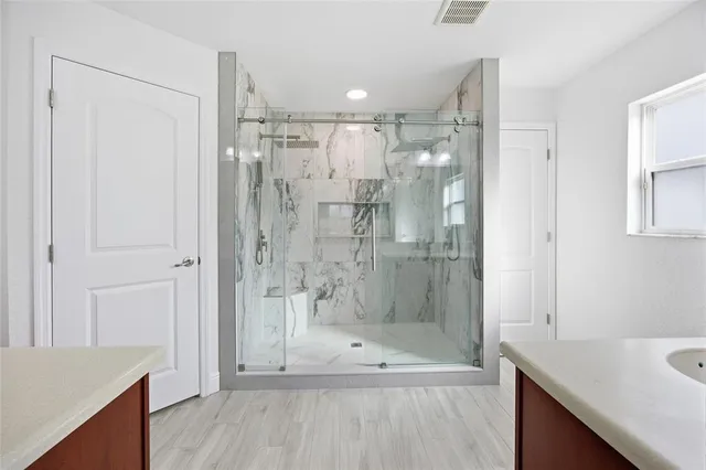 a bathroom with a shower and a sink