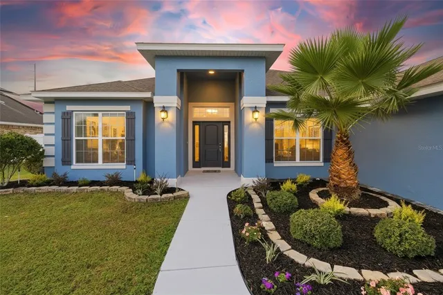 a front view of a house with outdoor seating