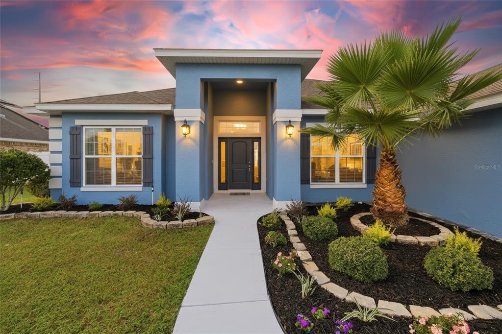 4863 Southwest 63rd Street Ocala, FL 34474 - Photo 2 of 41 a front view of a house with outdoor seating
