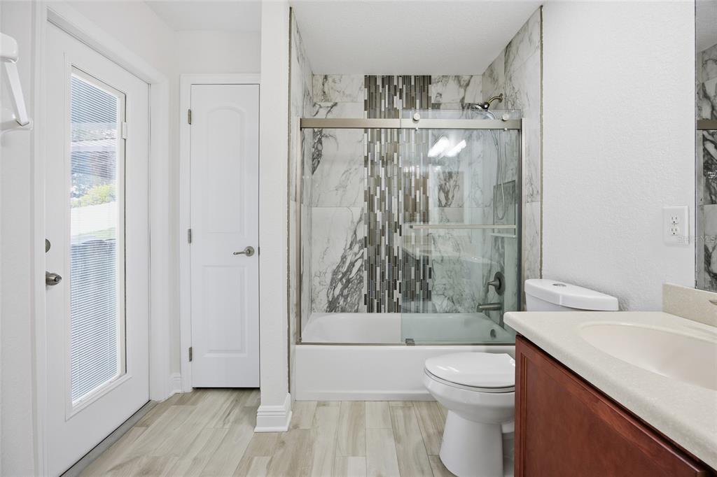 4863 Southwest 63rd Street Ocala, FL 34474 - Photo 25 of 41 a bathroom with a granite countertop toilet a sink and bathtub