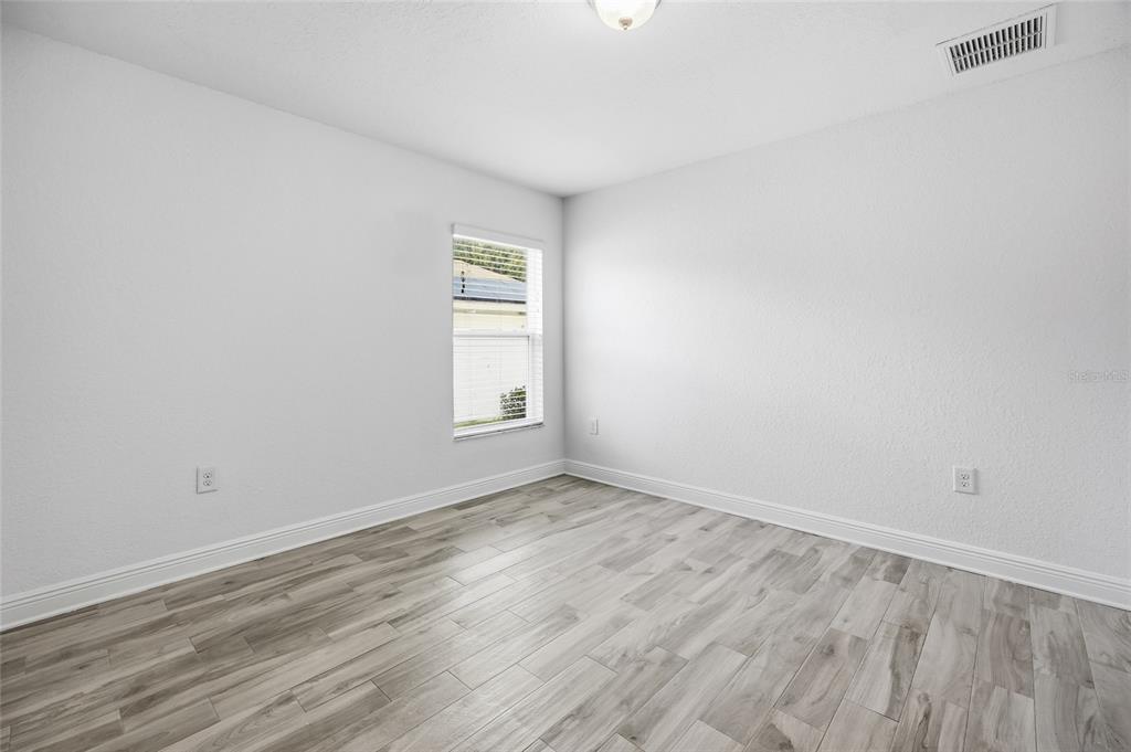4863 Southwest 63rd Street Ocala, FL 34474 - Photo 26 of 41 a view of empty room with wooden floor and fan