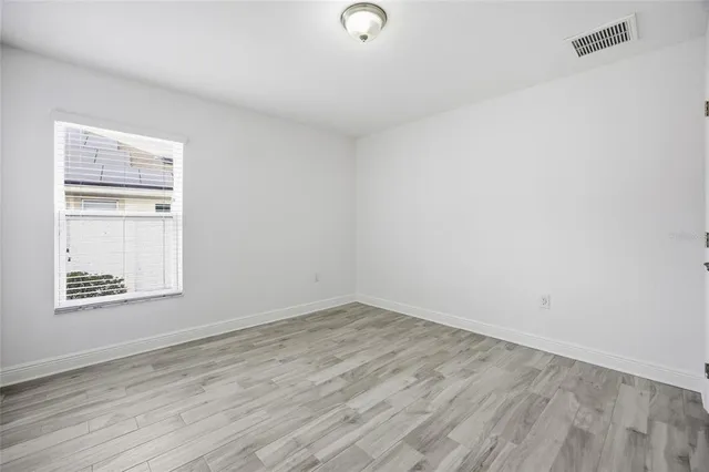 a view of an empty room and wooden floor