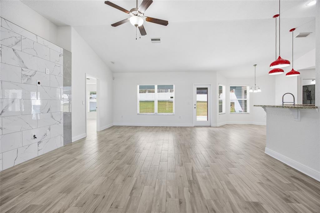 4863 Southwest 63rd Street Ocala, FL 34474 - Photo 6 of 41 a view of an empty room with window and wooden floor