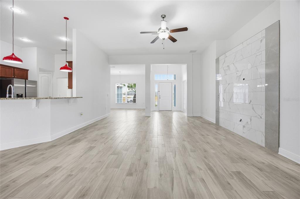 4863 Southwest 63rd Street Ocala, FL 34474 - Photo 9 of 41 a view of empty room with wooden floor and fan