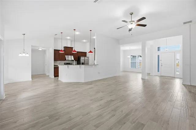 a view of a living room a kitchen and a wooden floor