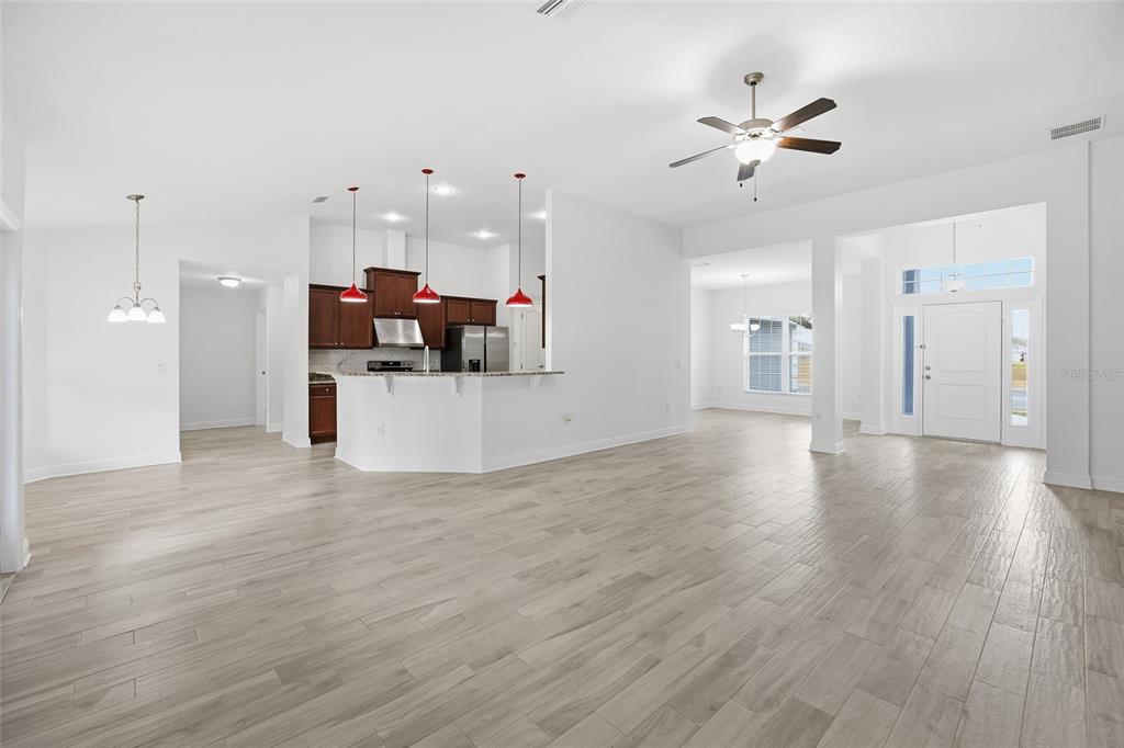 4863 Southwest 63rd Street Ocala, FL 34474 - Photo 10 of 41 a view of a living room a kitchen and a wooden floor