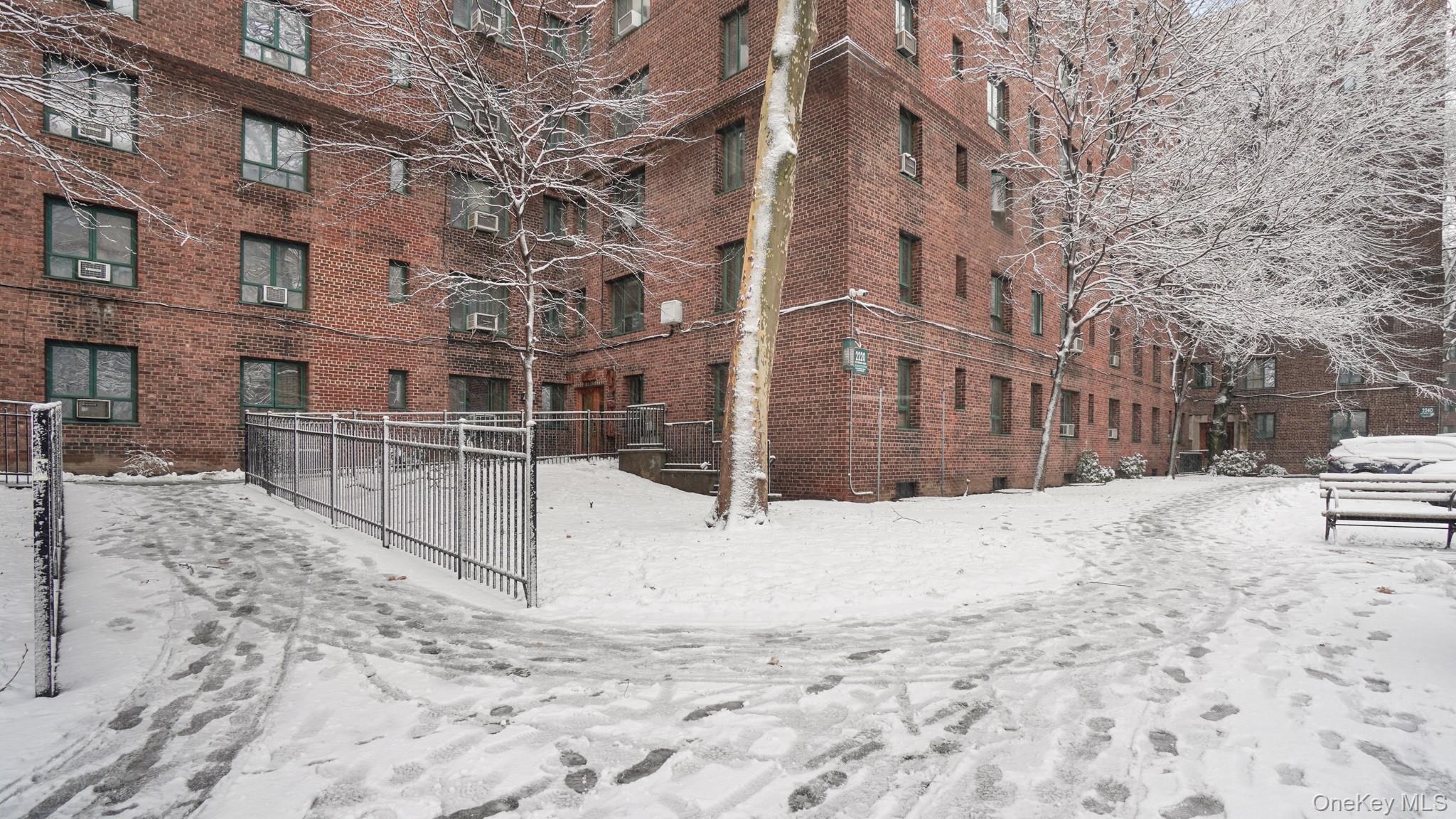 2220 East Tremont Avenue, Unit 7F Bronx, NY 10462 - Photo 13 of 13 Snow covered property featuring a view of apartment building / complex