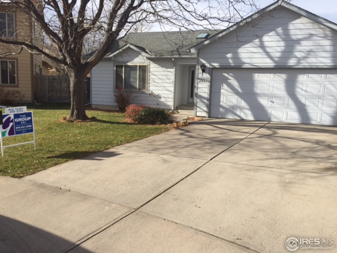 a view of a house with a yard and pathway