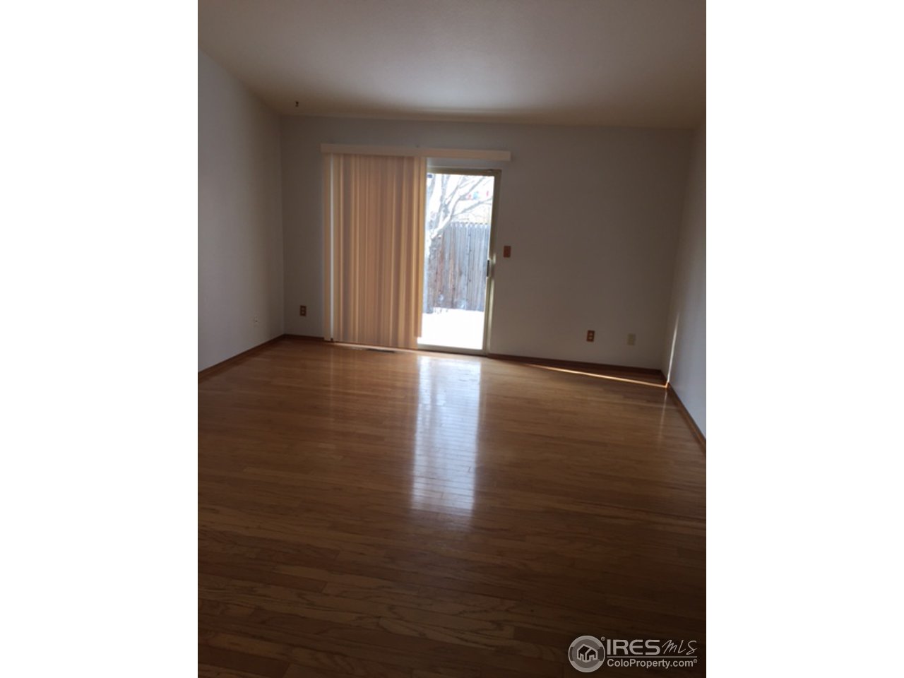 3335 Apollo Court Fort Collins, CO 80526 - Photo 4 of 10 a view of an empty room with wooden floor
