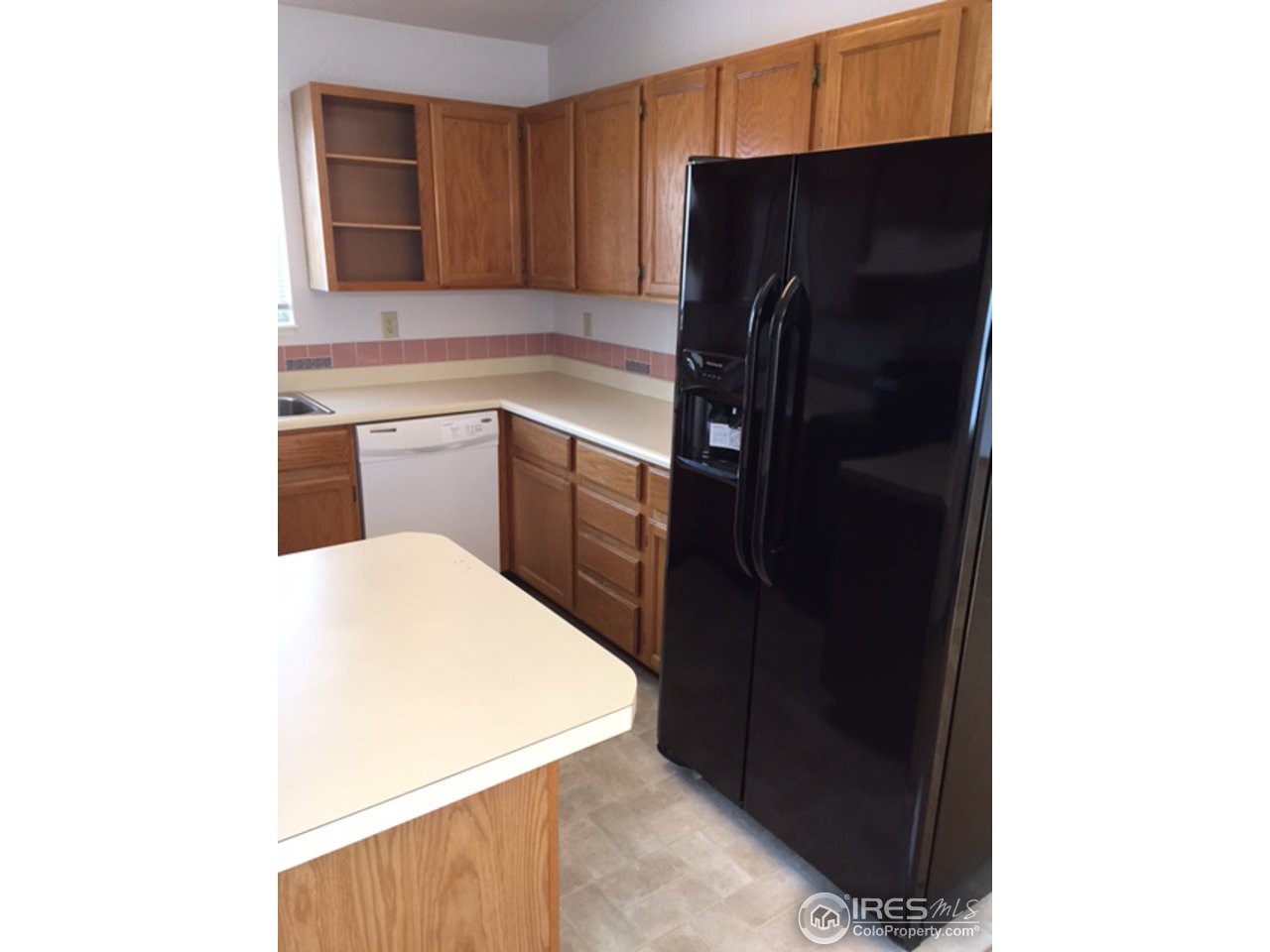 3335 Apollo Court Fort Collins, CO 80526 - Photo 5 of 10 a kitchen with a refrigerator and cabinets