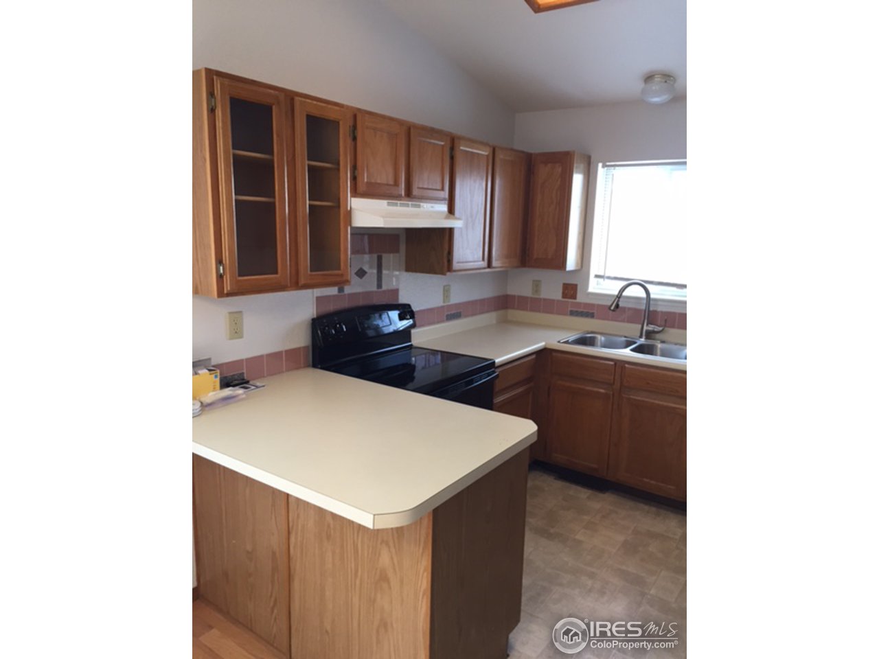 3335 Apollo Court Fort Collins, CO 80526 - Photo 6 of 10 a kitchen with a sink cabinets and a window