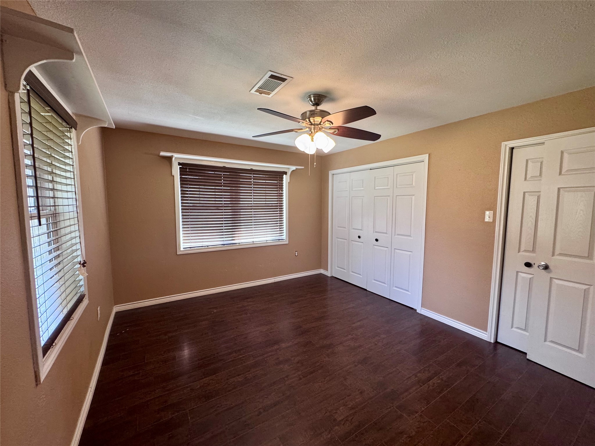 345 Rachal Avenue Bridge City, TX 77611 - Photo 12 of 25 a view of an empty room with a window and wooden floor