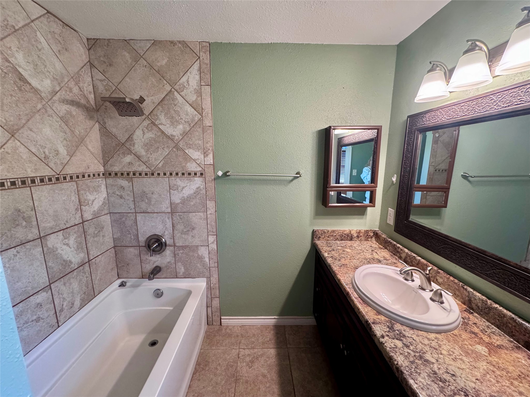 345 Rachal Avenue Bridge City, TX 77611 - Photo 14 of 25 a bathroom with a granite countertop bathtub sink vanity mirror and toilet