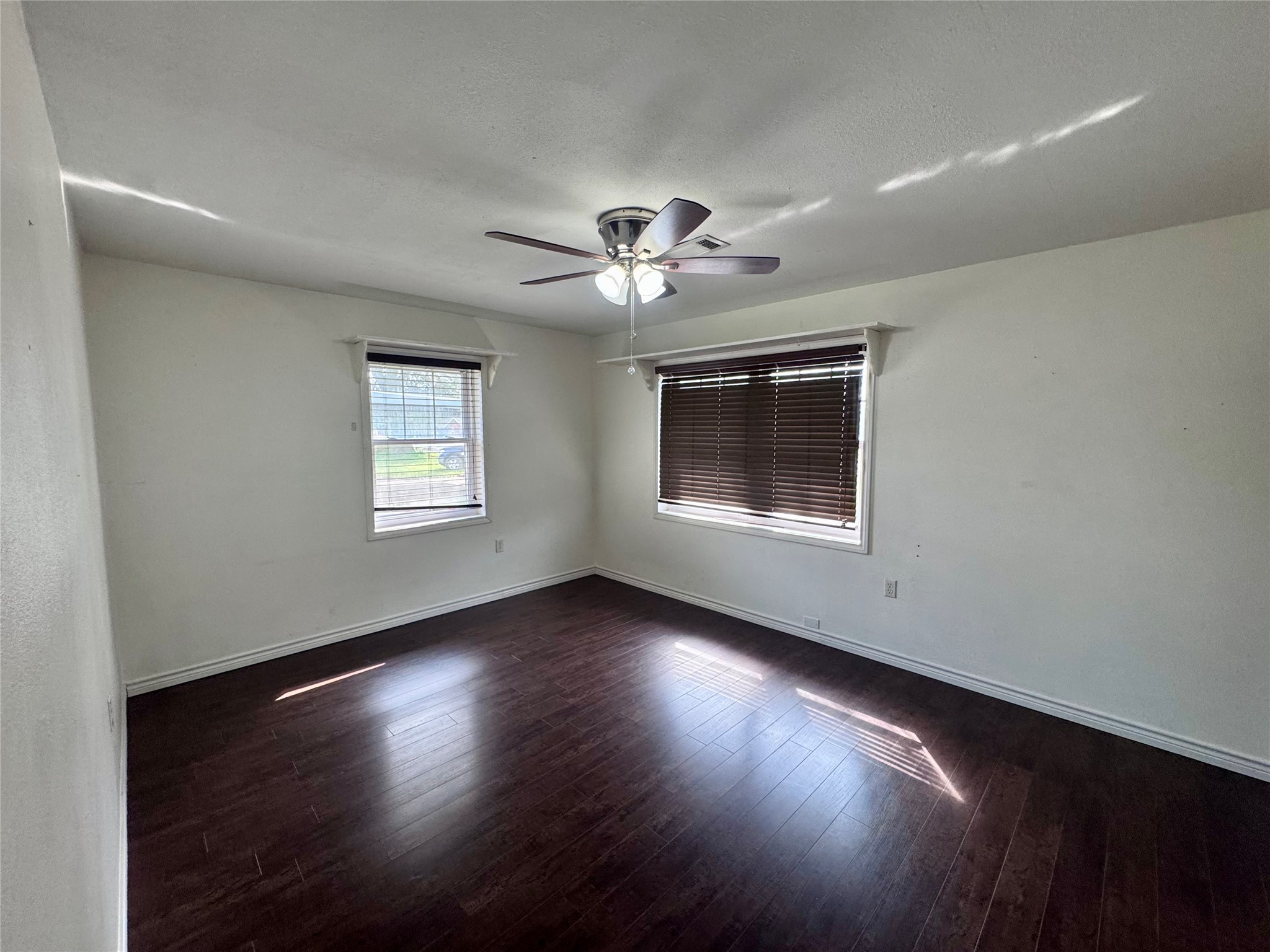 345 Rachal Avenue Bridge City, TX 77611 - Photo 15 of 25 a view of an empty room with wooden floor and a window