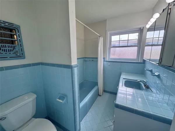 a bathroom with a sink and toilet