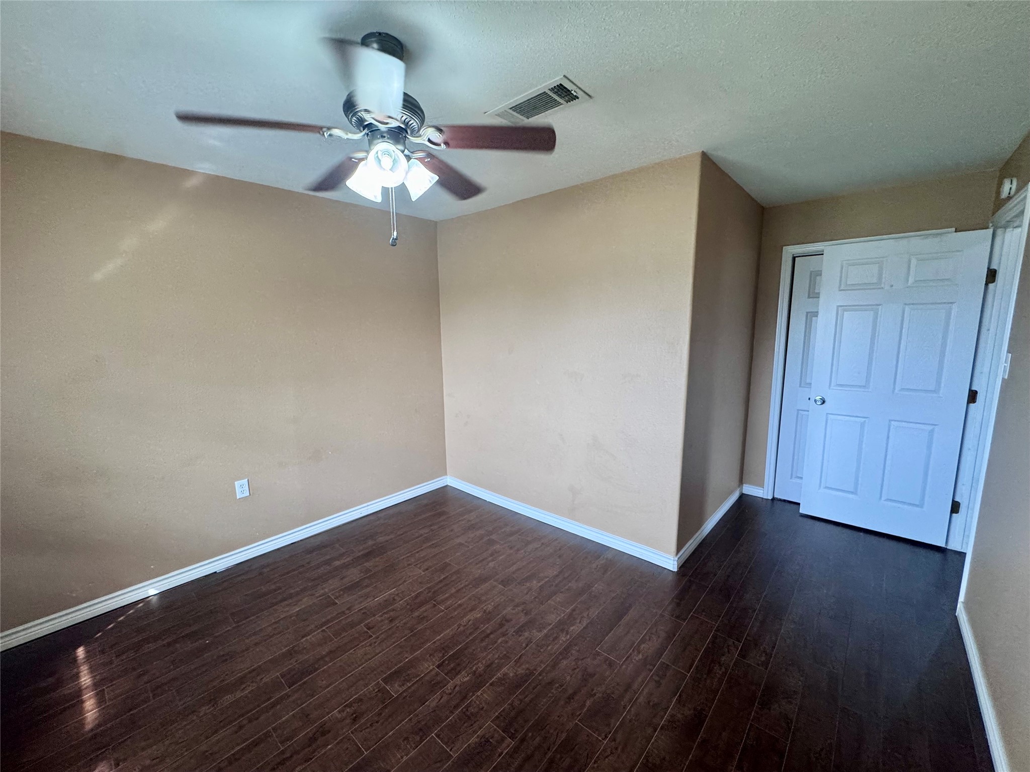 345 Rachal Avenue Bridge City, TX 77611 - Photo 18 of 25 a view of an empty room with wooden floor and a ceiling fan