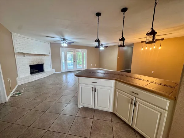 a kitchen with a sink and chandelier