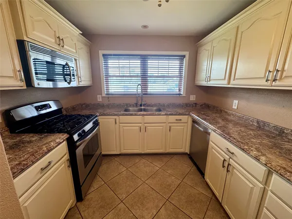 a white kitchen with a stove top oven