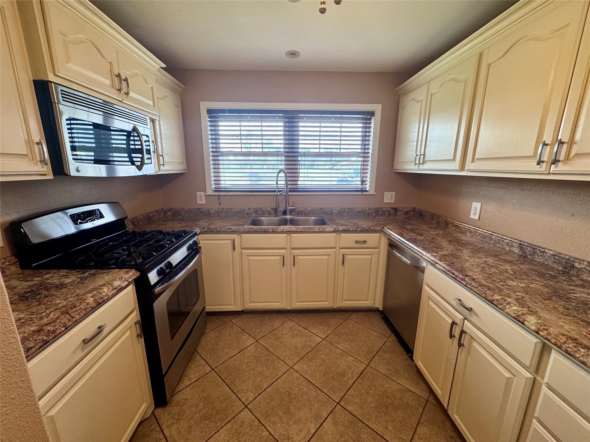 345 Rachal Avenue Bridge City, TX 77611 - Photo 7 of 25 a white kitchen with a stove top oven