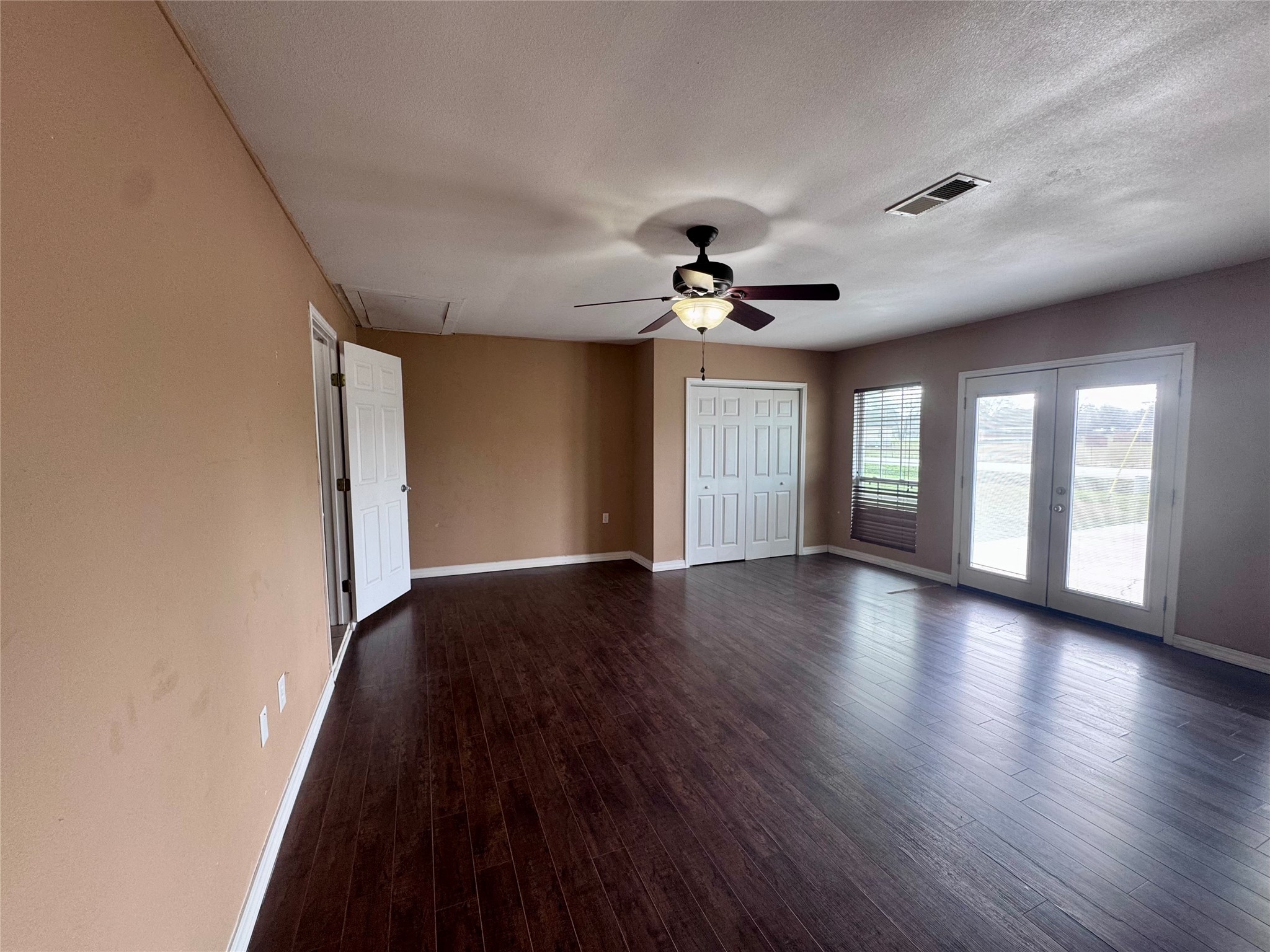 345 Rachal Avenue Bridge City, TX 77611 - Photo 9 of 25 a view of an empty room with a window and wooden floor