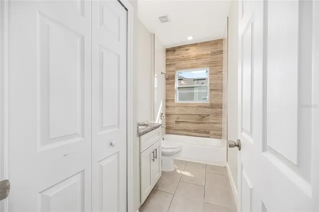 a bathroom with a granite countertop sink