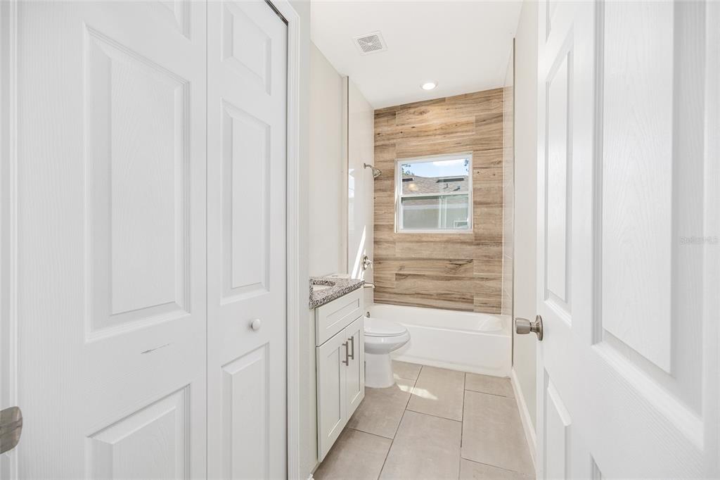 5998 Southwest 154th Street Road Ocala, FL 34473 - Photo 27 of 38 a bathroom with a granite countertop sink