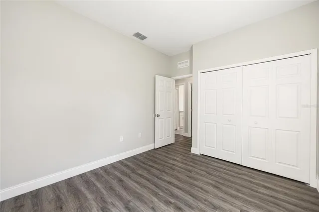 an empty room with wooden floor