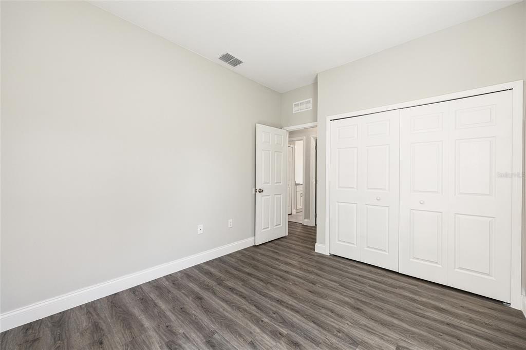 5998 Southwest 154th Street Road Ocala, FL 34473 - Photo 31 of 38 an empty room with wooden floor