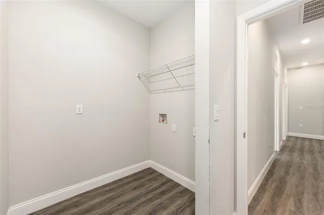 a view of a room with wooden floor