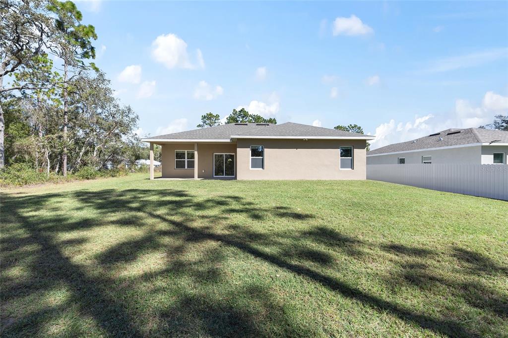 5998 Southwest 154th Street Road Ocala, FL 34473 - Photo 37 of 38 a front view of a house with a garden