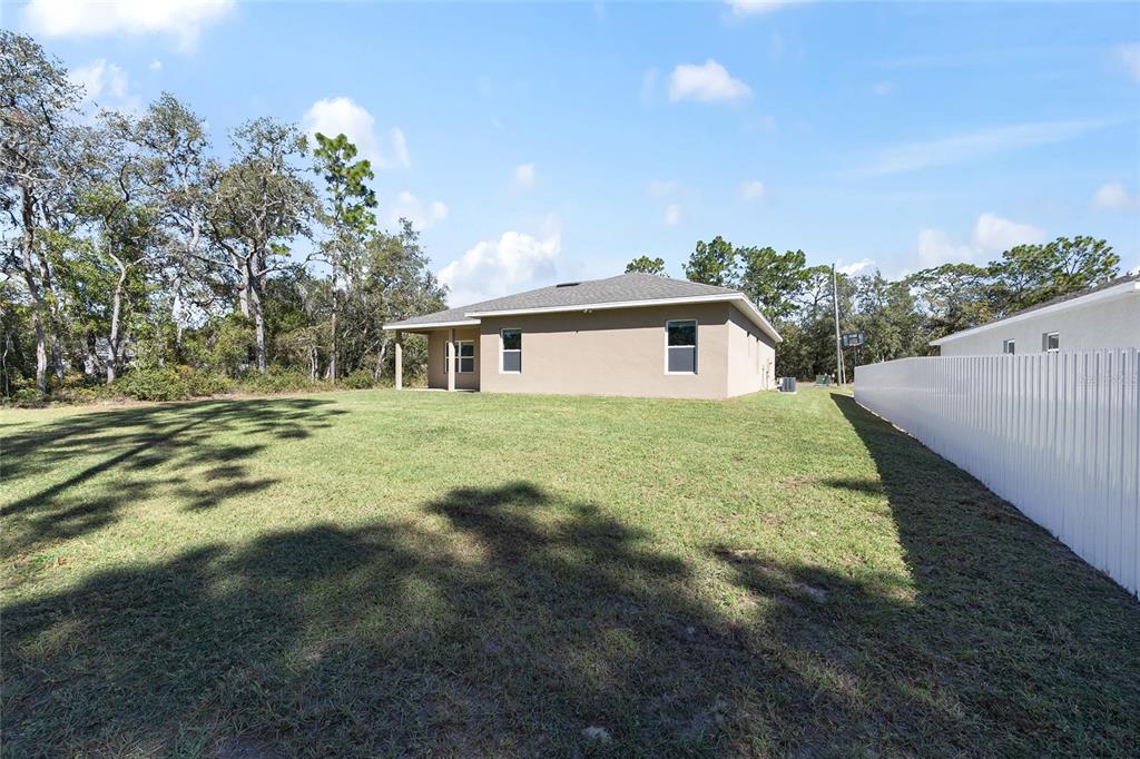 5998 Southwest 154th Street Road Ocala, FL 34473 - Photo 38 of 38 a view of a house with a yard