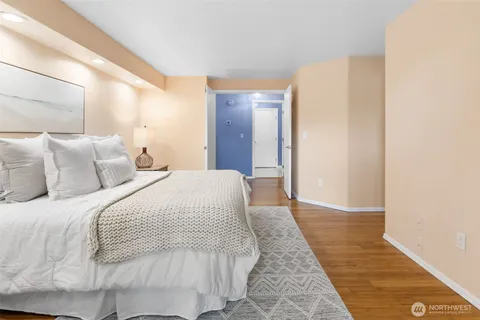 a bedroom with a bed and a mirror