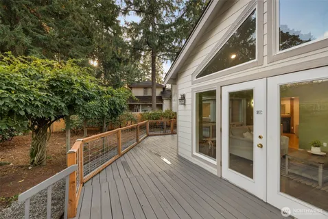 a view of a balcony with wooden floor and fence