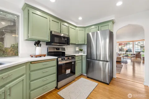 a kitchen with stainless steel appliances granite countertop a refrigerator stove and microwave