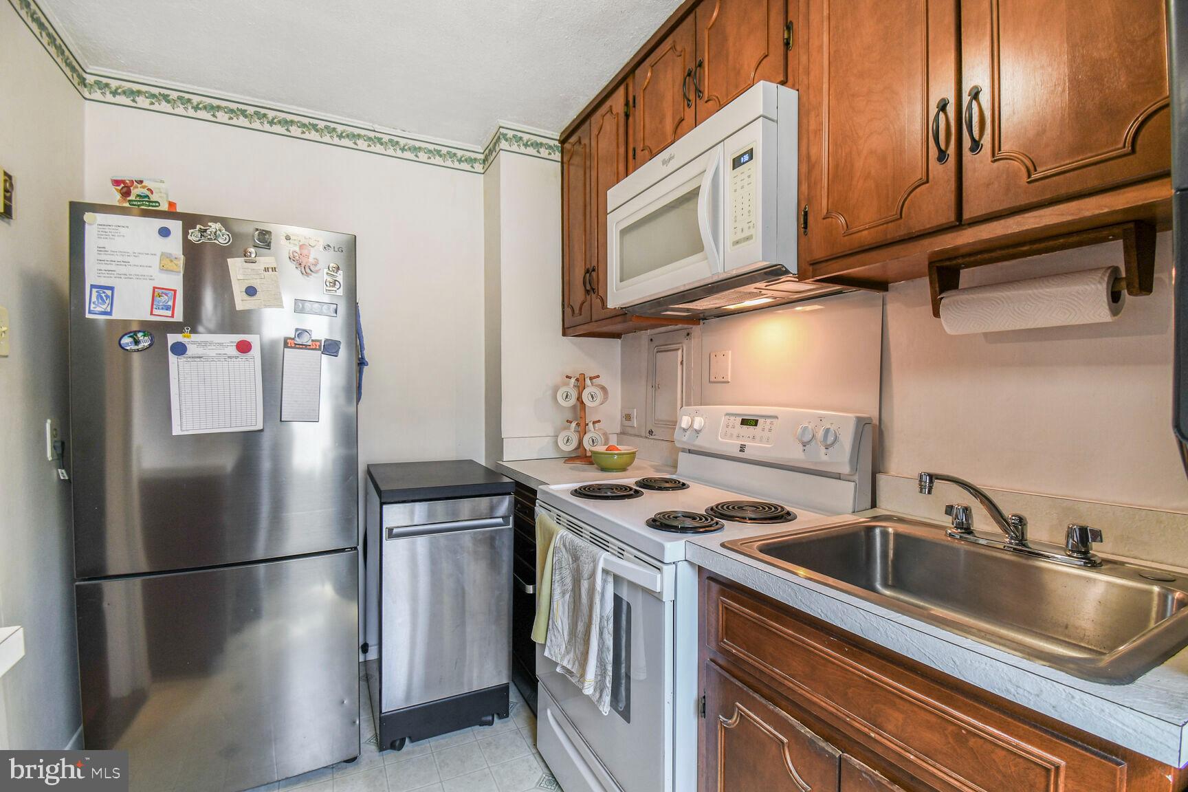 36 Ridge Road Greenbelt, MD 20770 - Photo 11 of 27 a kitchen with stainless steel appliances granite countertop a stove a refrigerator and a sink