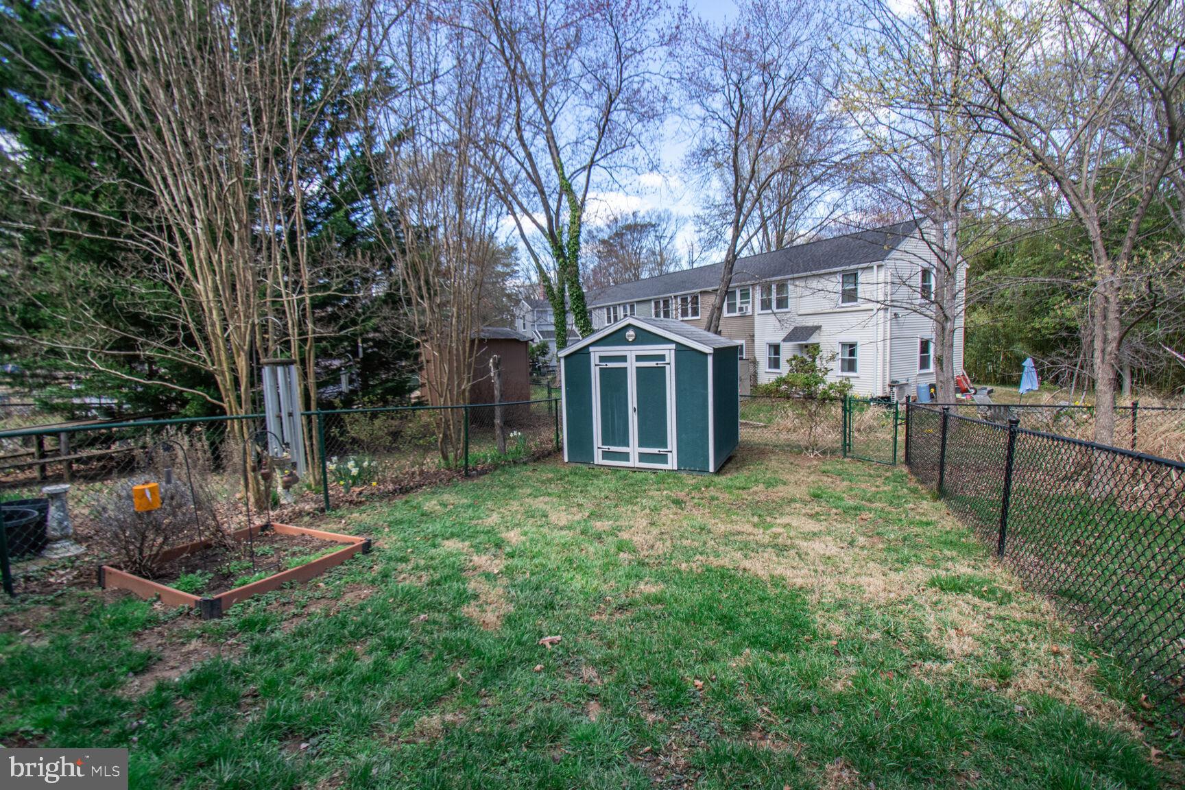 36 Ridge Road Greenbelt, MD 20770 - Photo 10 of 27 a view of a backyard with table and chairs potted plants and large tree