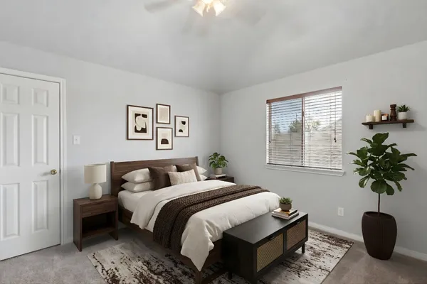 a bedroom with a bed and a potted plant