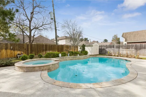 a view of a swimming pool with a yard