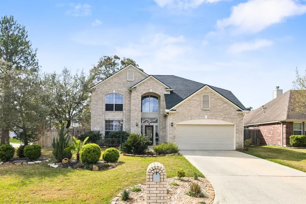 a front view of a house with a yard garage and outdoor seating