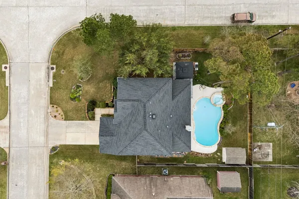 an aerial view of a house with outdoor space swimming pool