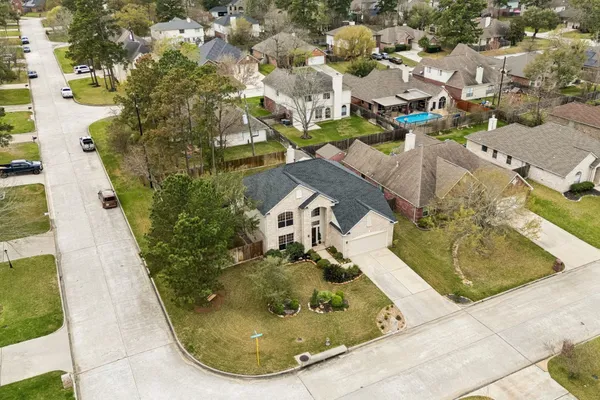 an aerial view of a house with a swimming pool