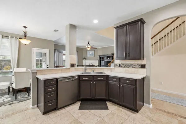 a large kitchen with a sink and cabinets