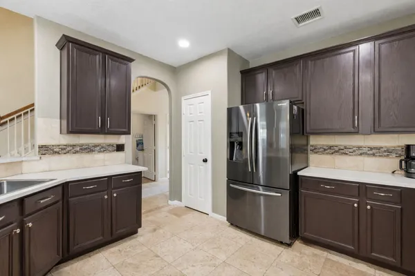 a kitchen with stainless steel appliances granite countertop a refrigerator and a sink